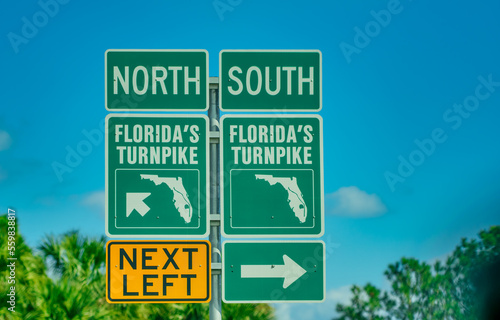 Florida's turnpike road signage against palms and blue sky