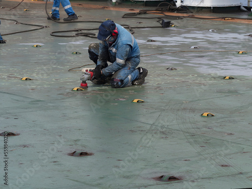 a sailor sanding main deck of a big ship photo