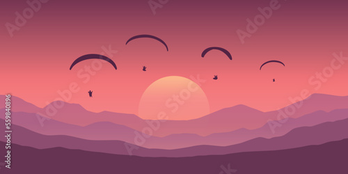 paragliding adventure flying with friends on purple mountain background at sunset