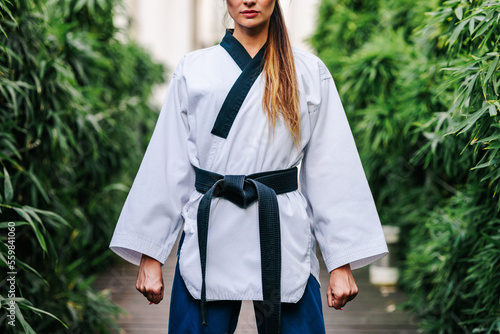 Anonymous professional TKD master standing on street photo