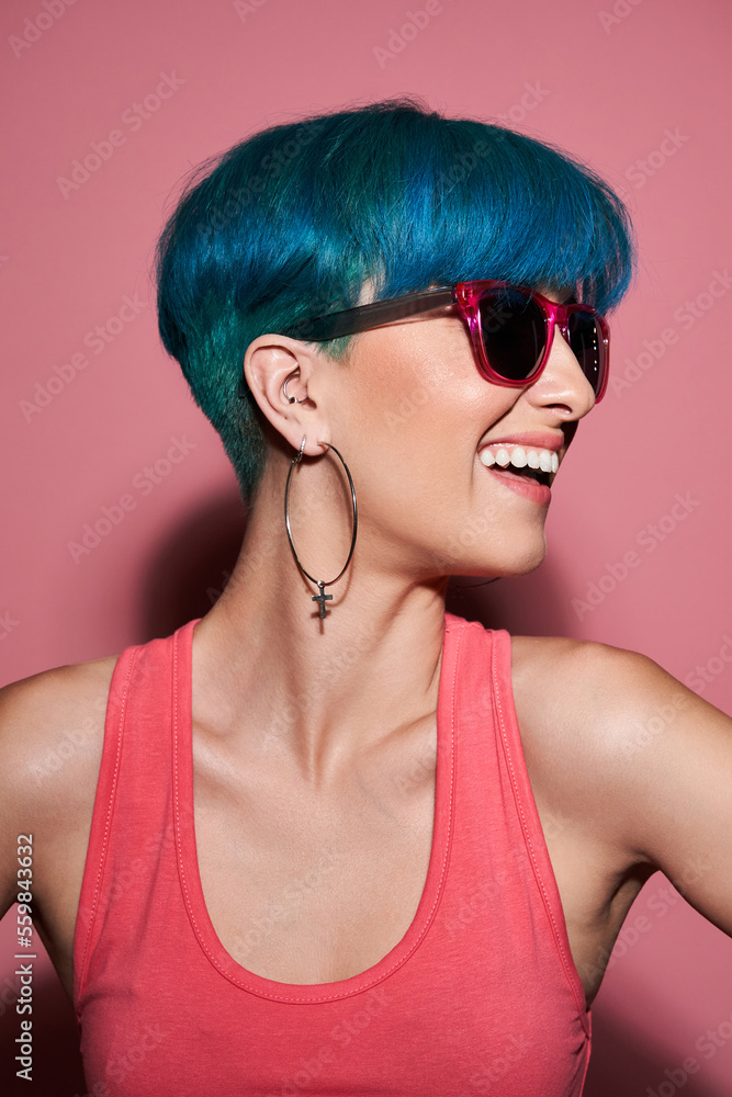 Cheerful woman with blue hair in studio Cheerful woman with blue hair in studio