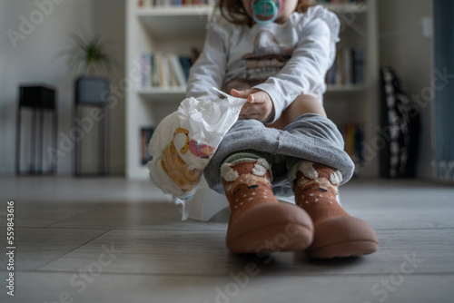 potty training small caucasian girl toddler child sitting on the potty photo