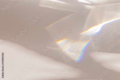 Sunlight background, abstract photo with light and shadow, glare and shine on paper texture, rainbow flare, beige monochrome minimal scene. Natural light and caustic effects, trend aesthetic photo