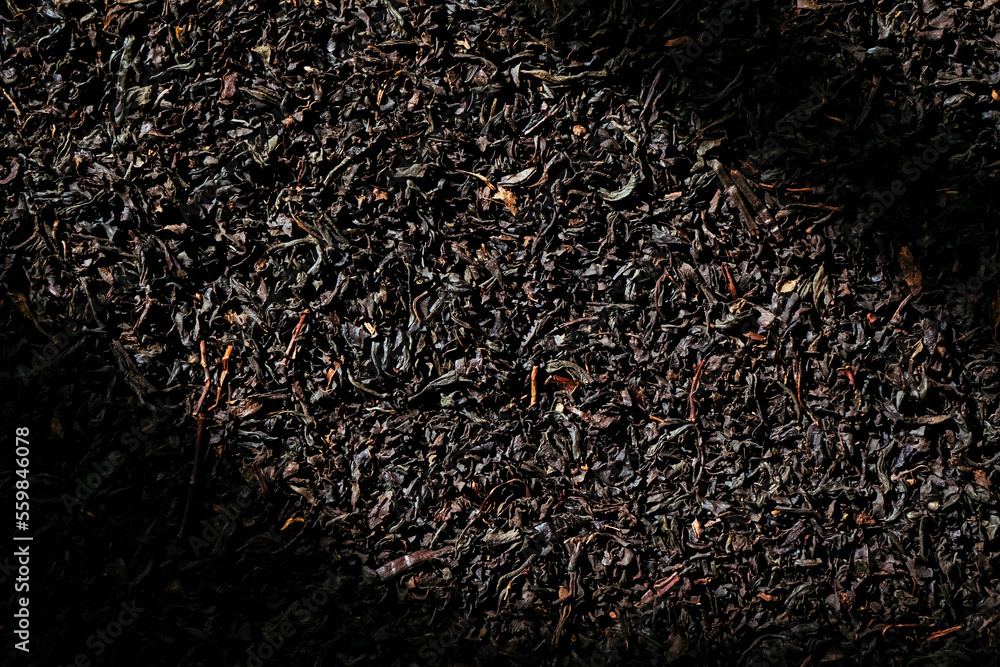 Dry tea leaves on dark background Dry tea leaves on dark background