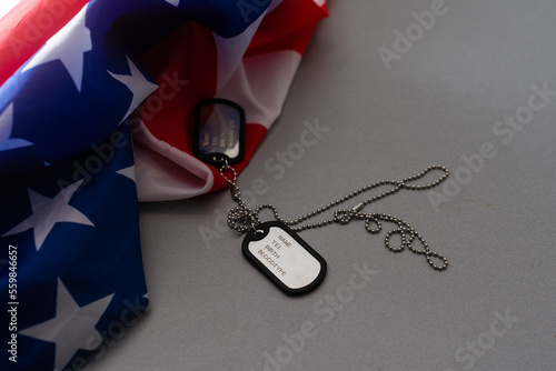 military forces, military service, patriotism and nationalism concept - close up of american flag and soldiers badges. photo