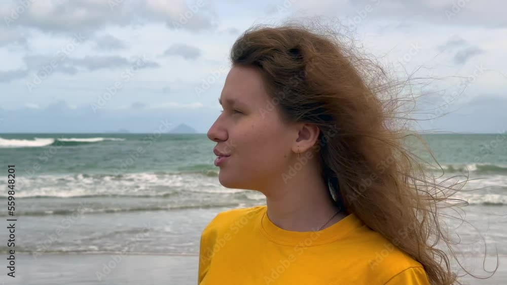 Portrait of happy positive red hair girl, young beautiful carefree woman enjoying summer vacation at sea, beach in exotic tropical country Portrait of happy positive red hair girl, young beautiful carefree woman enjoying summer vacation at sea, beach in exotic tropical country