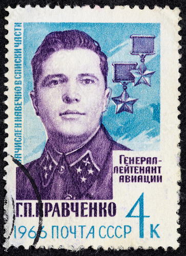 USSR - CIRCA 1966: Postage stamp 4 kopeck printed in the Soviet Union shows Portrait of Lieutenant General G. P. Kravchenko and Hero star medals. Post stamp series devoted to Heroes of World War II. photo
