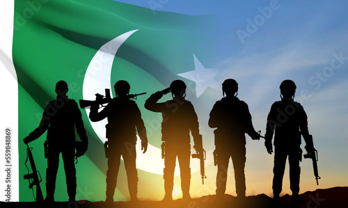SIlhouettes of soldiers on background of sunset and Pakistan Flag. Patriotic background. EPS10 vector