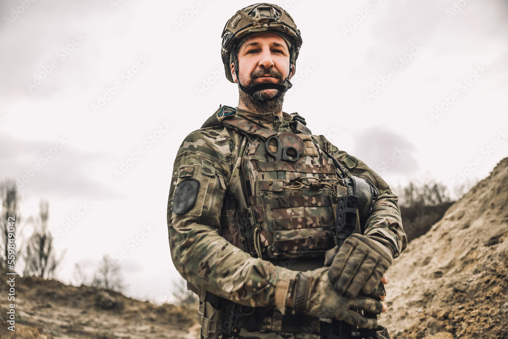 Mature man in military uniform and protective hemlet Mature man in military uniform and protective hemlet