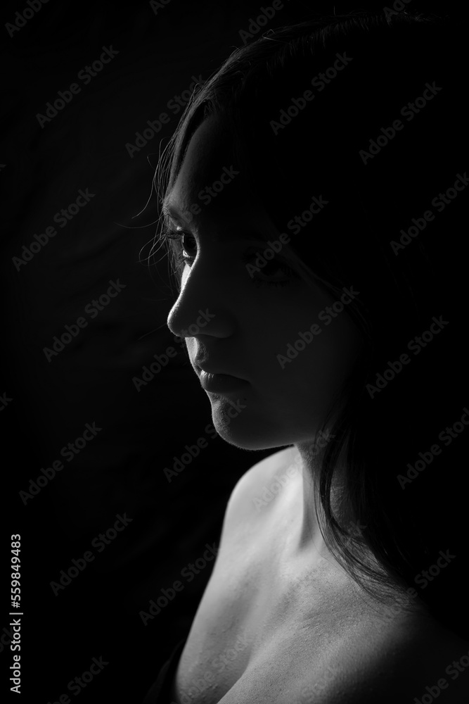 face of girl on a dark background with a back light