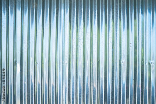 Metal stainless steel strips. Corrugated iron, Zinc wall, pattern texture. Close-up of exterior architecture material for design decoration background. © tampatra