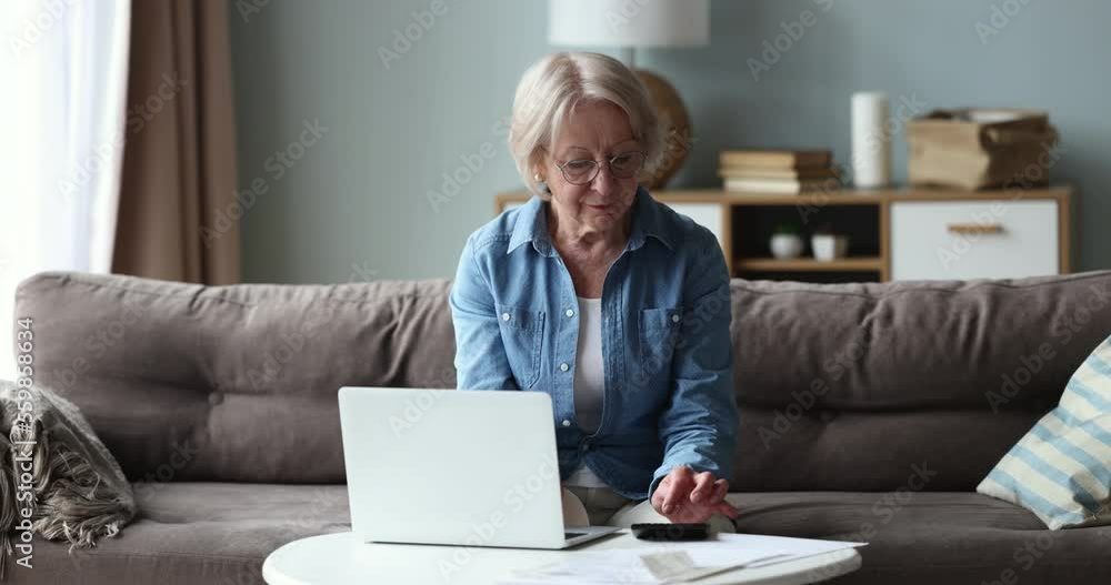 Older single woman feels stressed calculating household expenses, looks disappointed due to high electricity bills need to pay. Bankruptcy, insufficient old-age pension, huge taxes, bank debt, penalty Older single woman feels stressed calculating household expenses, looks disappointed due to high electricity bills need to pay. Bankruptcy, insufficient old-age pension, huge taxes, bank debt, penalty