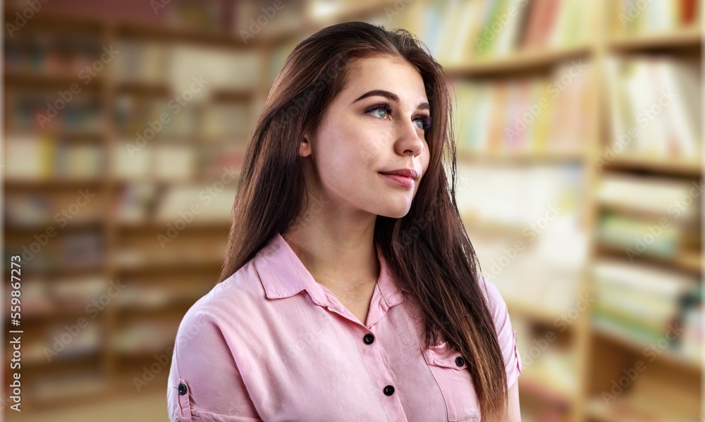 Pensive young student girl in the university library Pensive young student girl in the university library