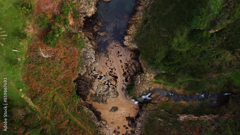 Top aerial view of ocean waves splashing against rocks background. High quality 4k footage Top aerial view of ocean waves splashing against rocks background. High quality 4k footage