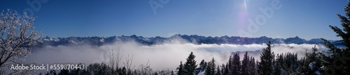 Allgäuer Berge in der Sonne und Nebel im Tal vom Wannenkopf photo