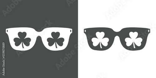Día de San Patricio. Silueta aislada de gafas de sol con reflejo de shamrock de 3 hojas en espacio negativo
