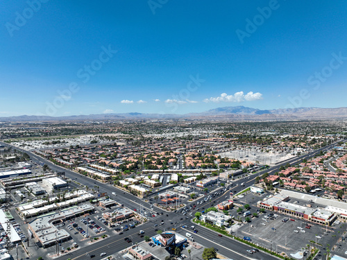 Aerial view across urban suburban communities in Las Vegas Nevada with streets, rooftops, and homes 