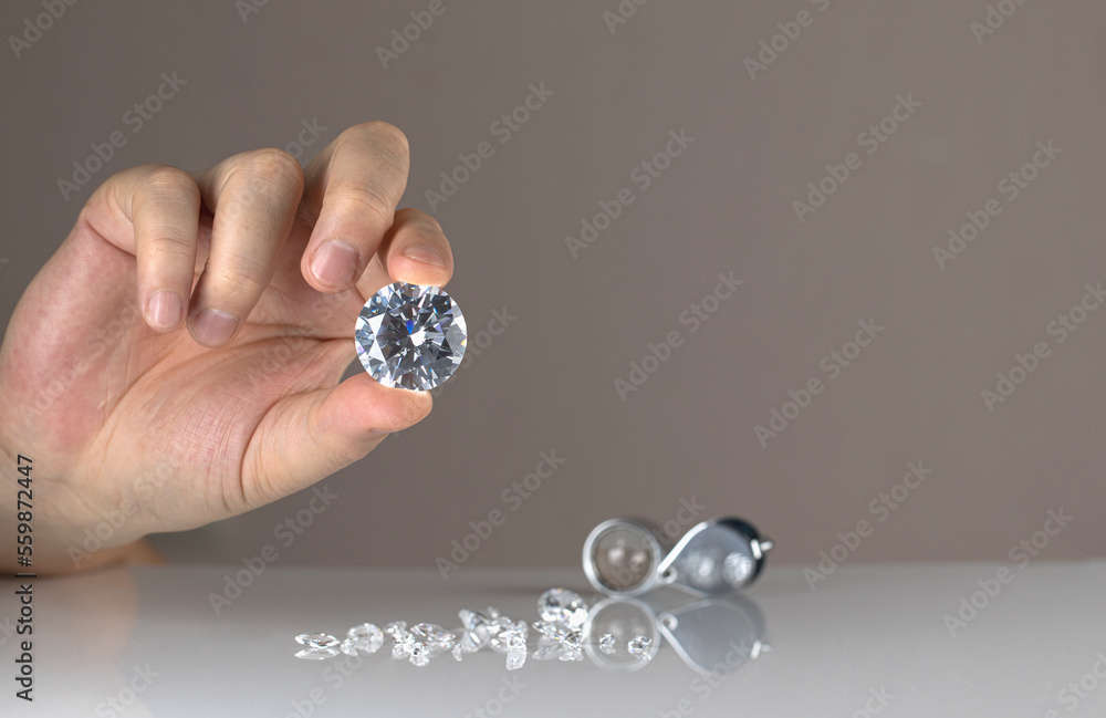 Gem stones diamonds of different cuts and sizes on the desktop of diamond dealer evaluating quality of polished diamonds. High quality photo Gem stones diamonds of different cuts and sizes on the desktop of diamond dealer evaluating quality of polished diamonds. High quality photo