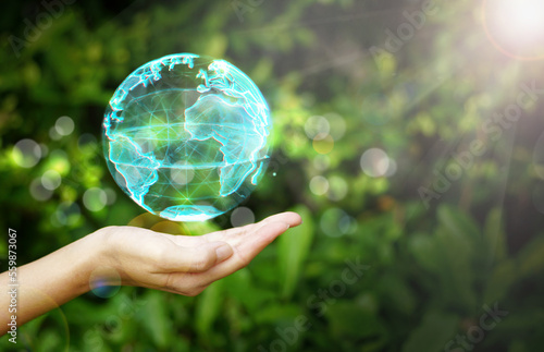 Hand holding a globe graphic on nature background, Renewable energy-based green businesses can limit climate change and global warming, environment, earth day, 
