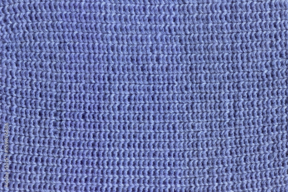 The texture of a hand-knitted natural woolen cloth with an English elastic band of blue color. A warm, winter woolen jacket. Close-up knitting, close-up loops. The texture of a hand-knitted natural woolen cloth with an English elastic band of blue color. A warm, winter woolen jacket. Close-up knitting, close-up loops.