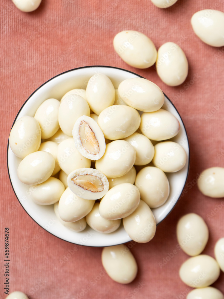 dragee from almonds in white chocolate. Chocolate balls with nut filling. dragee from almonds in white chocolate. Chocolate balls with nut filling.