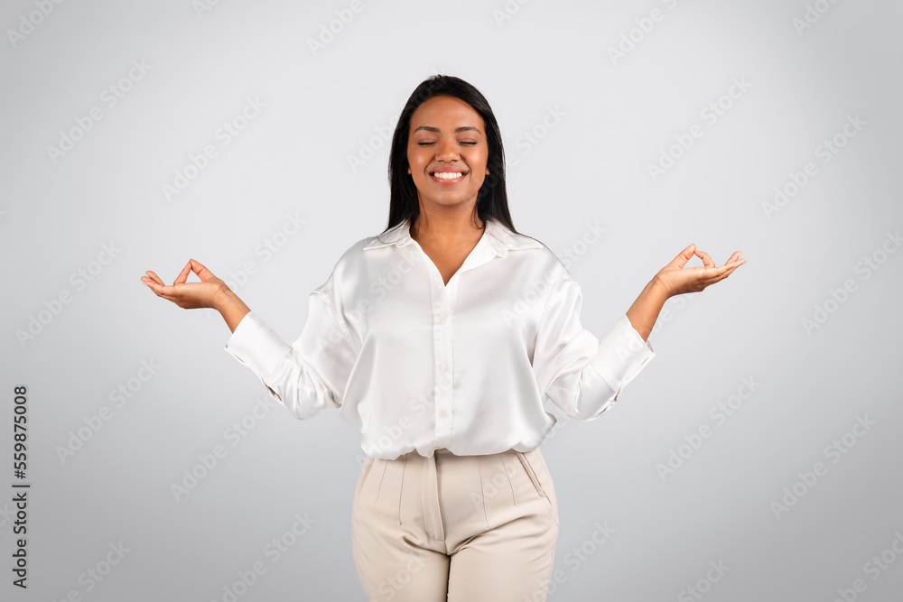 Glad serene millennial black female in white blouse with closed eyes meditation, enjoy spare time Glad serene millennial black female in white blouse with closed eyes meditation, enjoy spare time