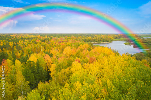 Taiga forests in the interfluve of the Ob and Irtysh rivers. Western Siberia. Autumn. There's a rainbow in the sky. photo