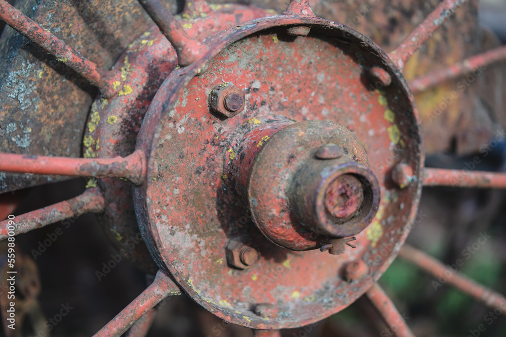 old rusty metal wheel with spokes for work in agriculture old rusty metal wheel with spokes for work in agriculture