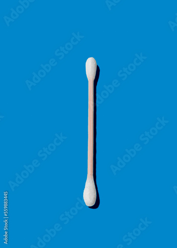 Ear stick, made of bamboo, on blue background. photo