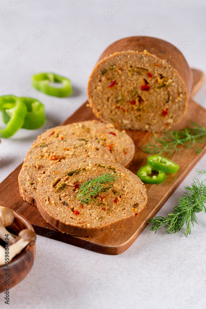 Mushroom based vegan sausage with vegetables and spices on wooden board, top view Mushroom based vegan sausage with vegetables and spices on wooden board, top view