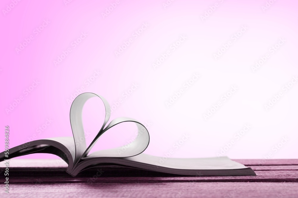 Love concept. Open reading book an pages in heart form Love concept. Open reading book an pages in heart form