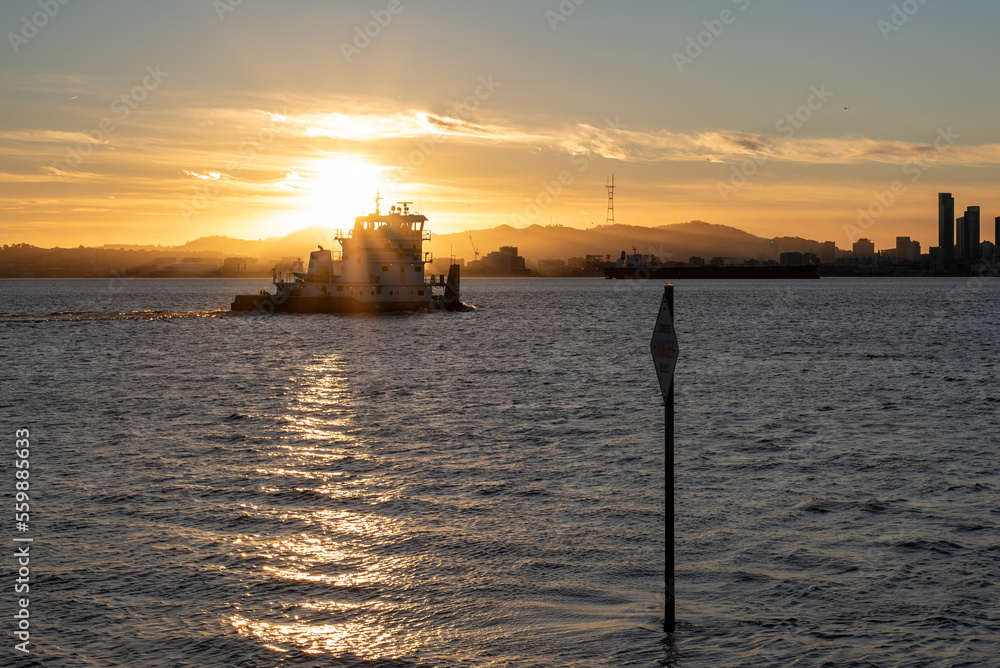 tugboat in front of sunset over bay tugboat in front of sunset over bay