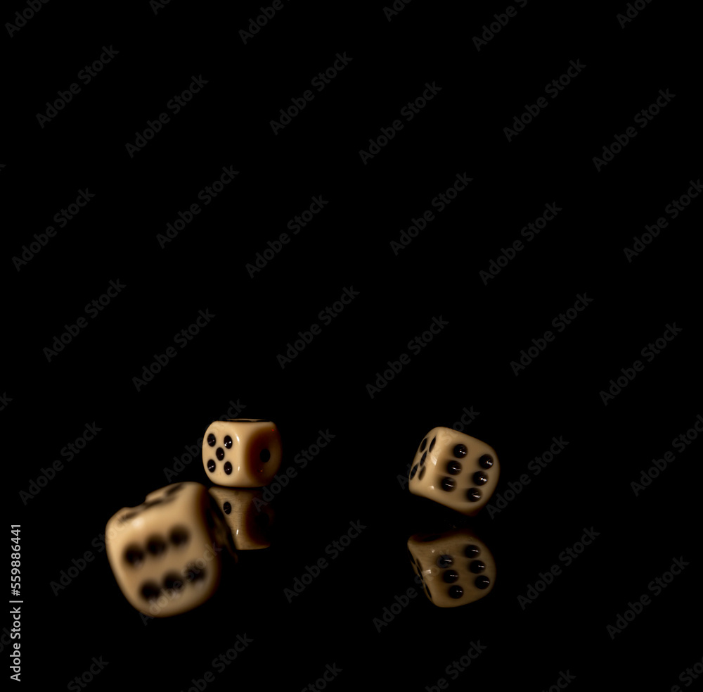 Game cubes on shiny black table with dark reflection