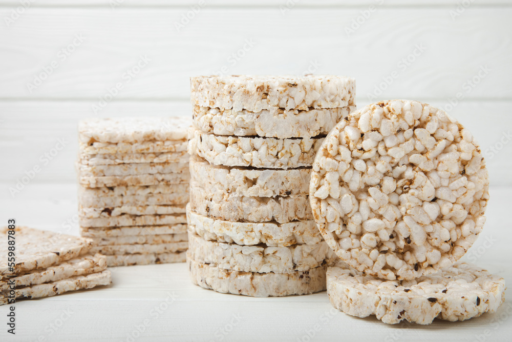 Stack of crispy rice cakes on white texture wood. Diet bread. Diet. proper nutrition. GLUTEN FREE. Copy space. Place for text. Stack of crispy rice cakes on white texture wood. Diet bread. Diet. proper nutrition. GLUTEN FREE. Copy space. Place for text.