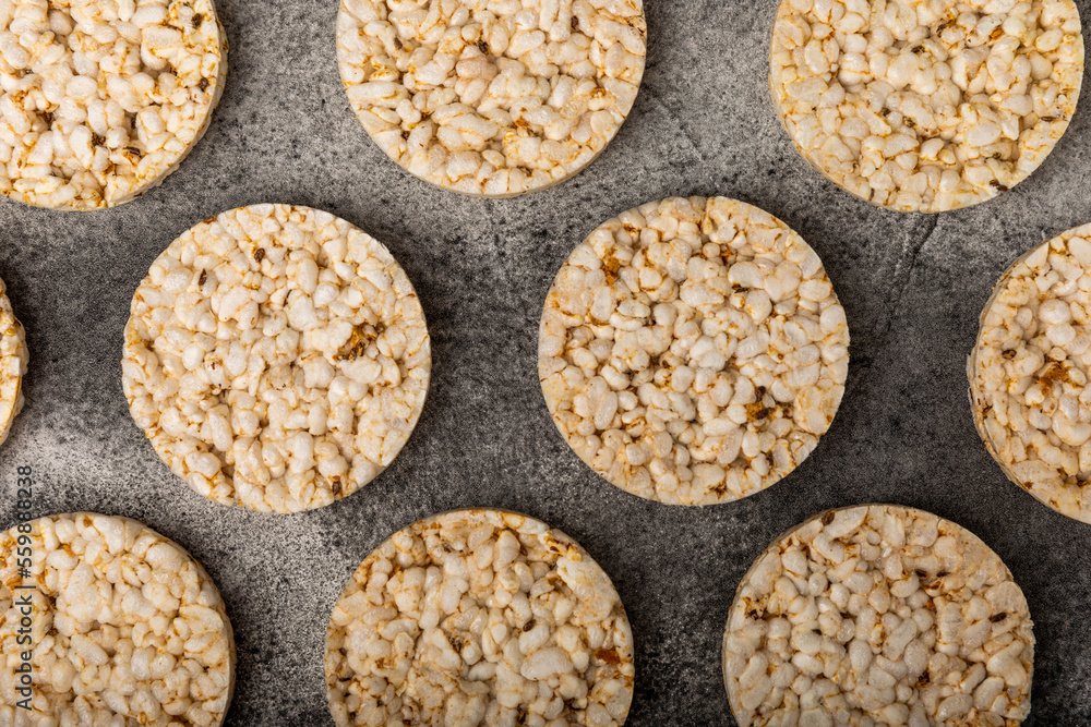Stack of crispy rice cakes on black textured background. Diet bread. Diet. proper nutrition. GLUTEN FREE. Copy space. Place for text. Stack of crispy rice cakes on black textured background. Diet bread. Diet. proper nutrition. GLUTEN FREE. Copy space. Place for text.