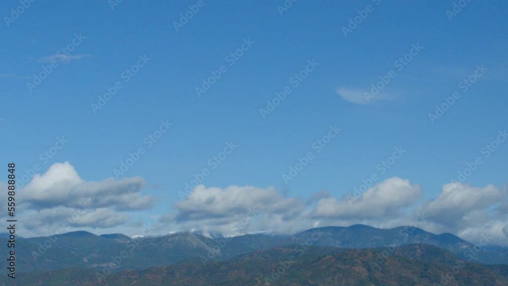 Time laps of mountain peaks and clouds. White clouds glide between the mountain peaks. Mountain delightful landscape Time laps of mountain peaks and clouds. White clouds glide between the mountain peaks. Mountain delightful landscape