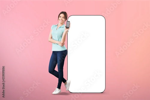 Happy young woman near huge mobile phone