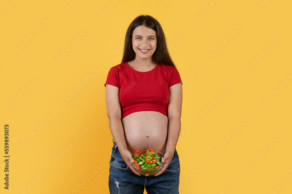 Beautiful Young Pregnant Woman With Bowl Of Fresh Vegetable Salad In Hands Beautiful Young Pregnant Woman With Bowl Of Fresh Vegetable Salad In Hands