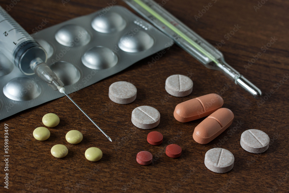 Group of different medical pills and capsules on the dark table close-up Group of different medical pills and capsules on the dark table close-up
