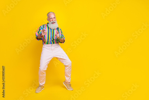 Full length photo of impressed funky man wear colorful shirt pointing fingers you empty space isolated yellow color background
