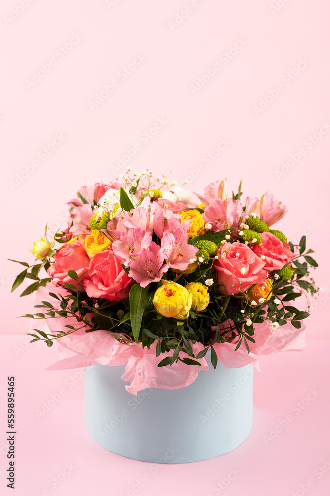 Bouquet of pink, yellow roses and purple flowers alstroemeria on a pink background. Birthday greeting card, Valentine's Day, Mother's Day