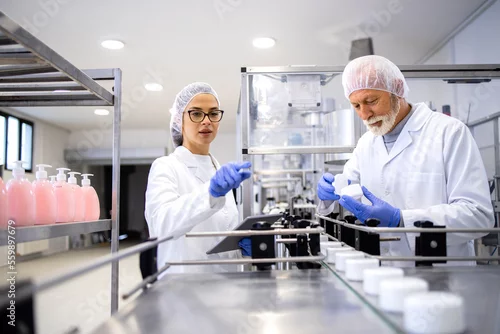 Obraz Production of pharmaceutical and cosmetics products inside factory and workers checking quality.