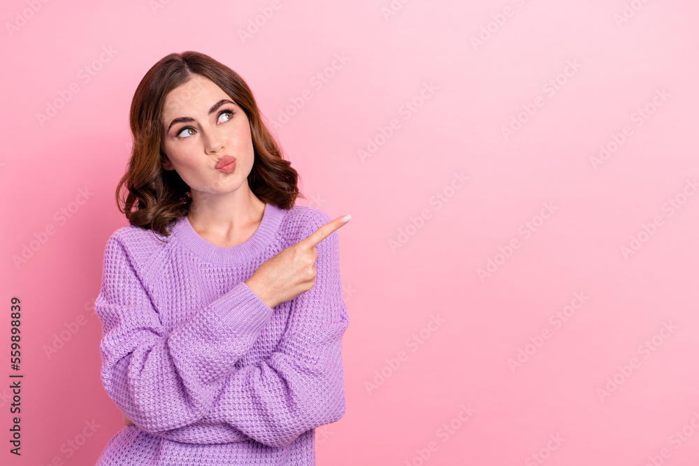 Portrait of thoughtful pretty girl with curly hairdo wear violet pullover indicating look empty space isolated on pink color background Portrait of thoughtful pretty girl with curly hairdo wear violet pullover indicating look empty space isolated on pink color background