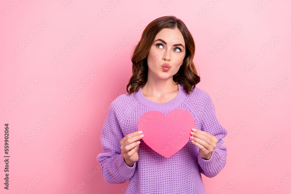 Photo of tender lovely lady blow lips wear stylish outfit hold paper card interested look empty space isolated on pink color background Photo of tender lovely lady blow lips wear stylish outfit hold paper card interested look empty space isolated on pink color background