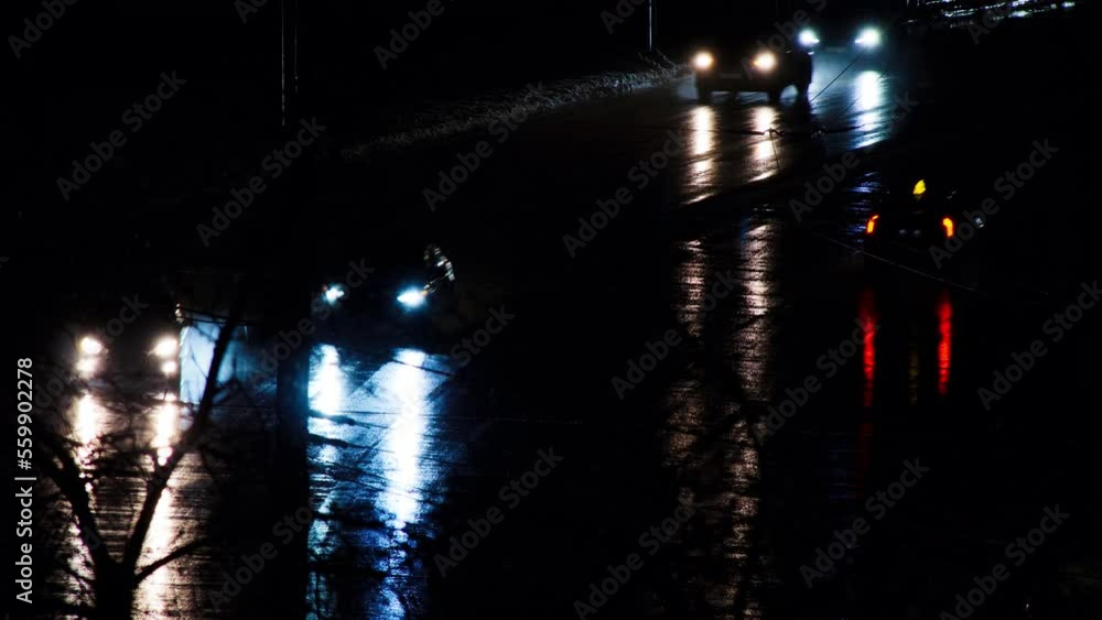 Cars drive on a night road in the rain. Cars on the night city highway ...
