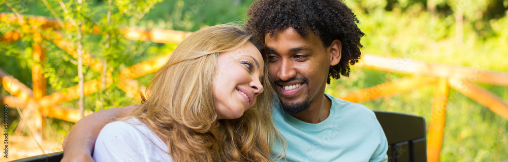 Young couple hugging in nature on a sunny summer day Young couple hugging in nature on a sunny summer day