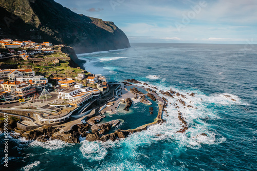 Aerial view of Porto Moniz with volcanic lava swimming pools,Madeira.Saltwater natural pools created in lava formations by Atlantic ocean.Gorgeous views,relaxation,crystal-clear water.