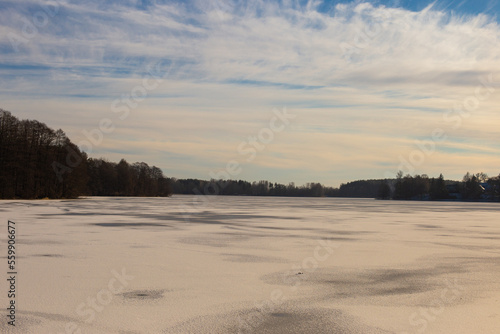 Trakai lake covered with ice in pleasant sunny cold winter day.