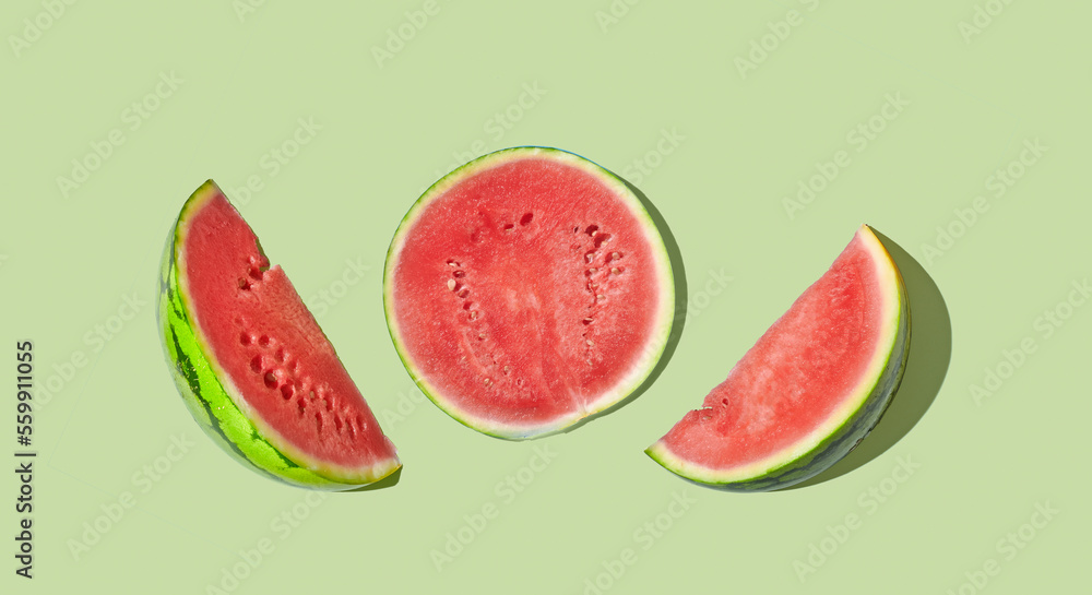 Cut watermelon on green pastel background Cut watermelon on green pastel background
