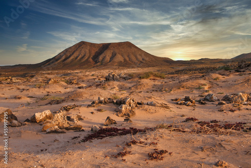 Desert landscape with a volcano in the background near Majanicho village, Fuerteventura island, Canary Island, Spain